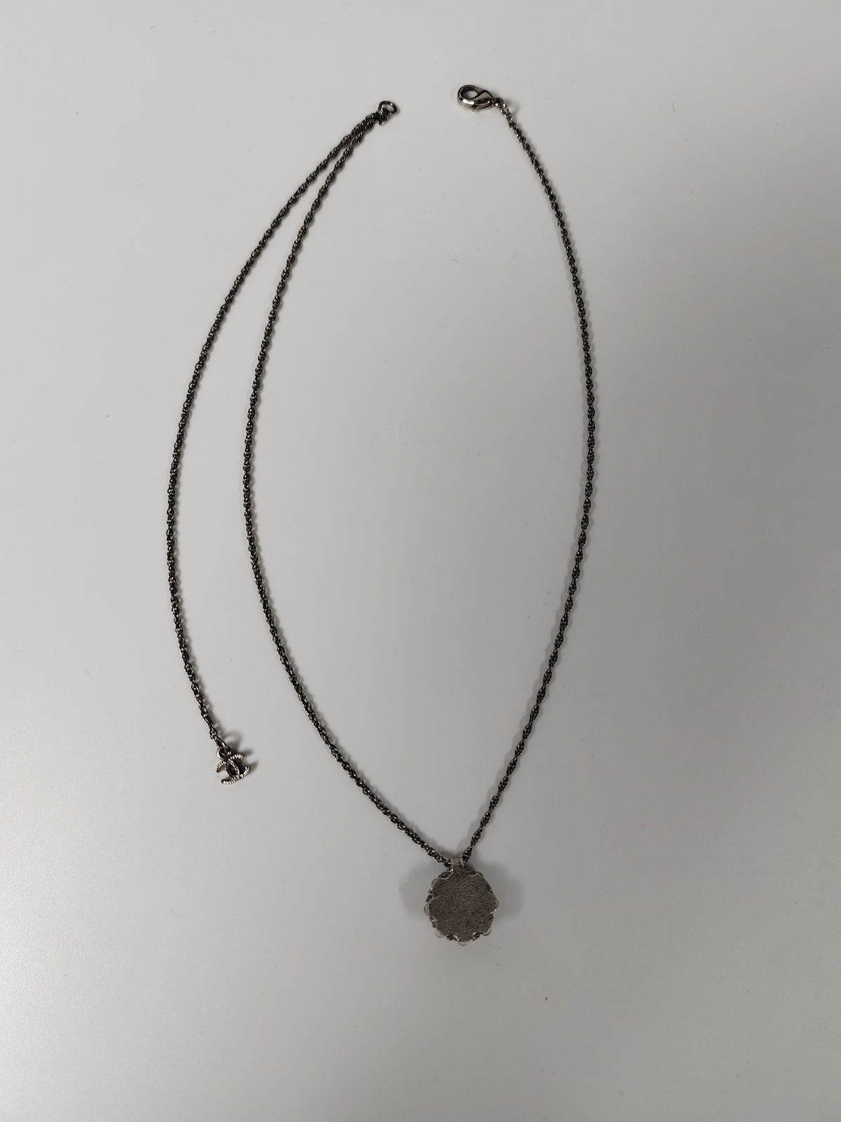 Chanel - Other - Silver-tone metal alloy with clear rhinestone accents and dark round decorative beads. - Silver