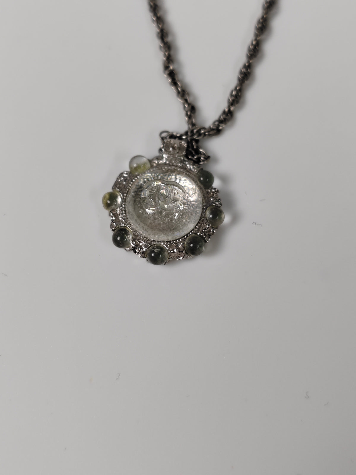 Chanel - Other - Silver-tone metal alloy with clear rhinestone accents and dark round decorative beads. - Silver