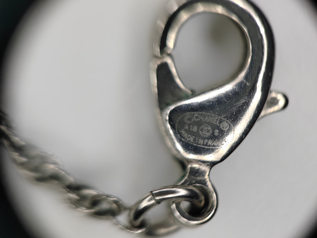 Chanel - Other - Silver-tone metal alloy with clear rhinestone accents and dark round decorative beads. - Silver
