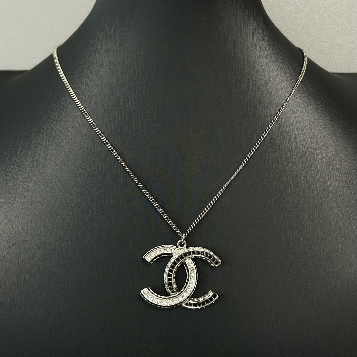 Chanel - Other - Silver-tone metal with clear and black glass-like embellishments; exact stone composition is unconfirmed. - Silver