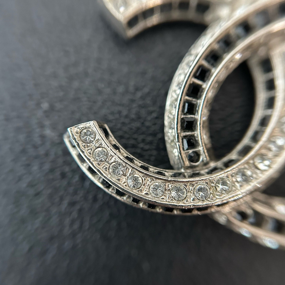 Chanel - Other - Silver-tone metal with clear and black glass-like embellishments; exact stone composition is unconfirmed. - Silver