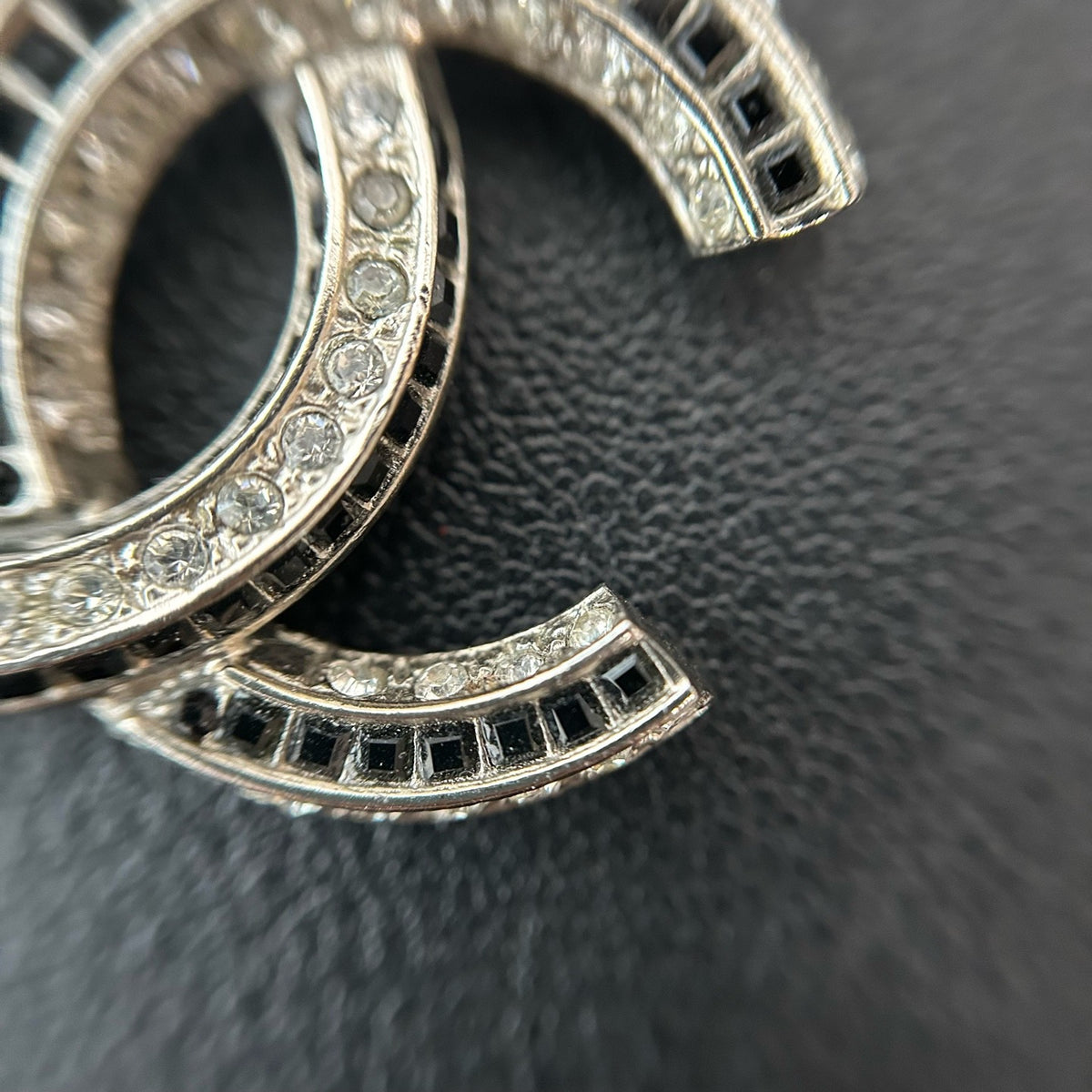 Chanel - Other - Silver-tone metal with clear and black glass-like embellishments; exact stone composition is unconfirmed. - Silver