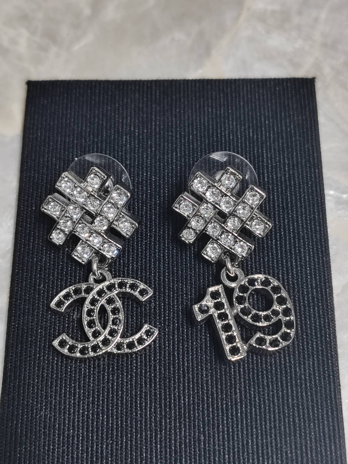 Chanel - Other - Silver-tone metal with clear and black rhinestone accents. - Multicolour
