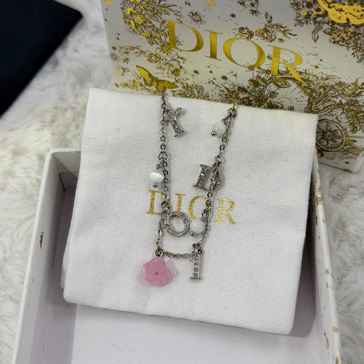 Dior - Other - Silver-tone metal chain and charms with decorative stones, white bead accents and a glass flower charm. - Multicolour