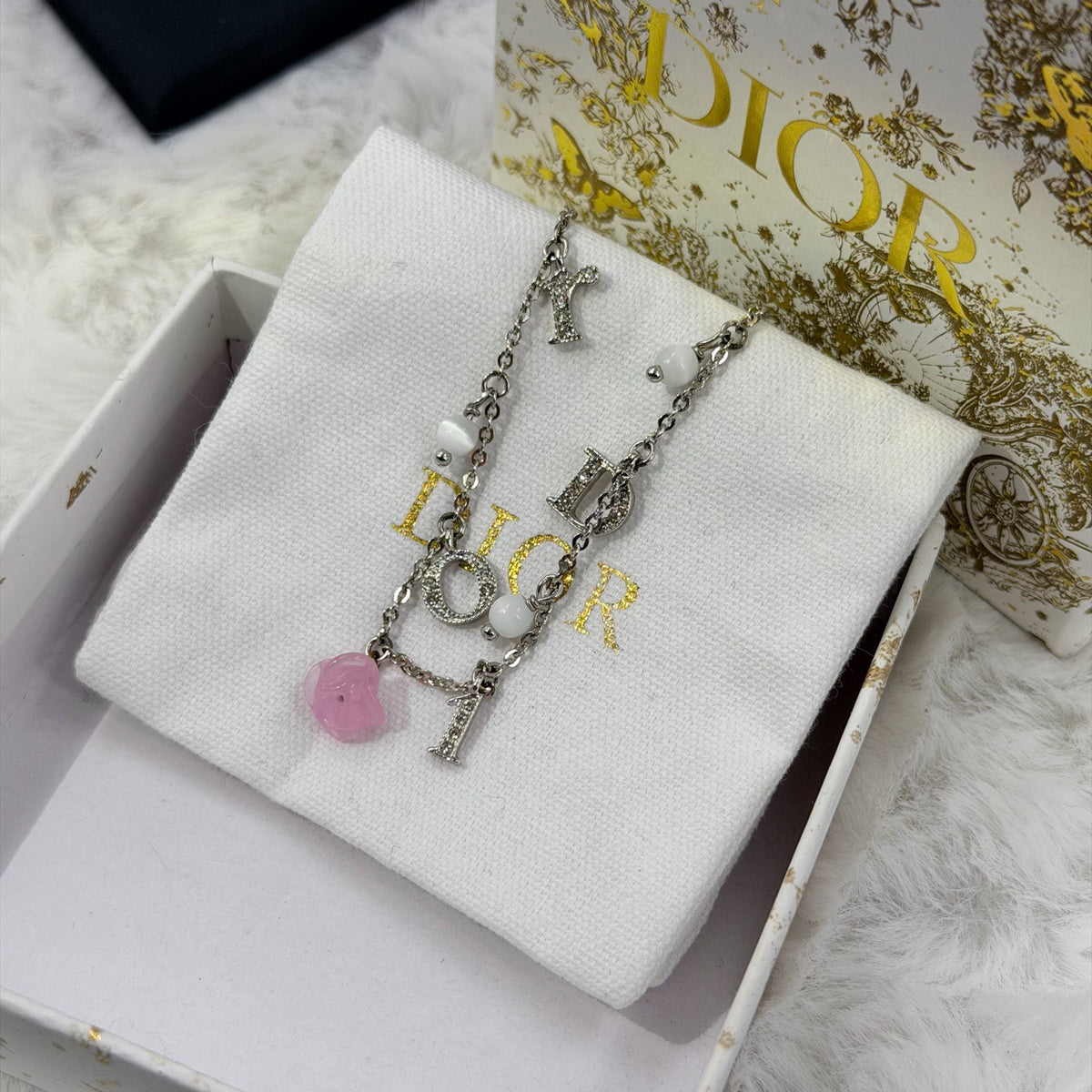 Dior - Other - Silver-tone metal chain and charms with decorative stones, white bead accents and a glass flower charm. - Multicolour