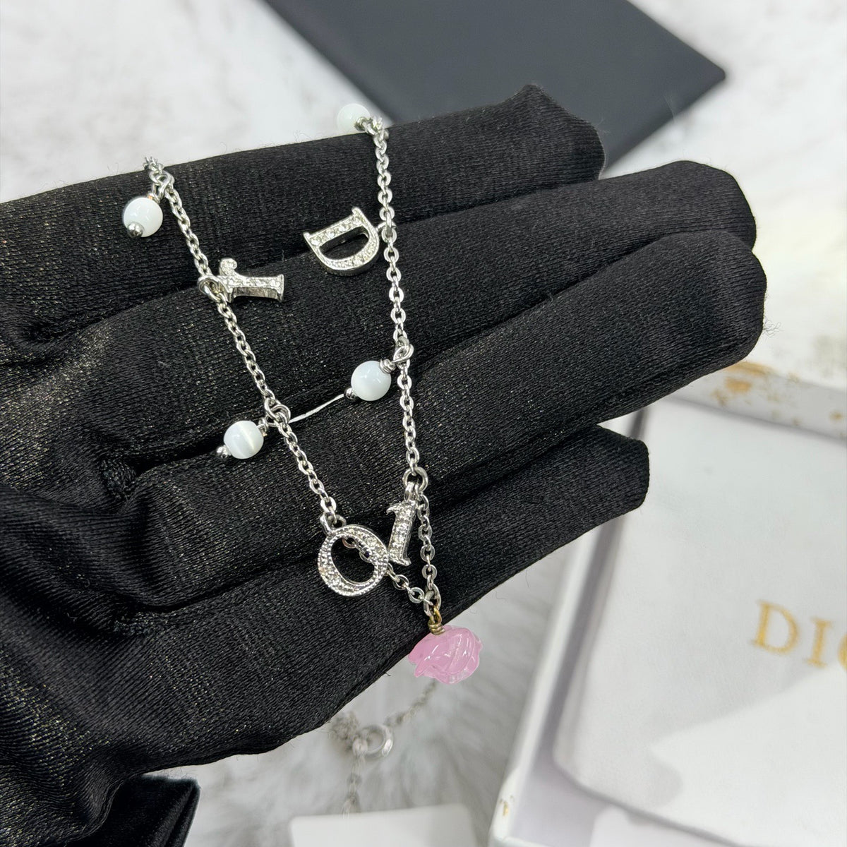 Dior - Other - Silver-tone metal chain and charms with decorative stones, white bead accents and a glass flower charm. - Multicolour