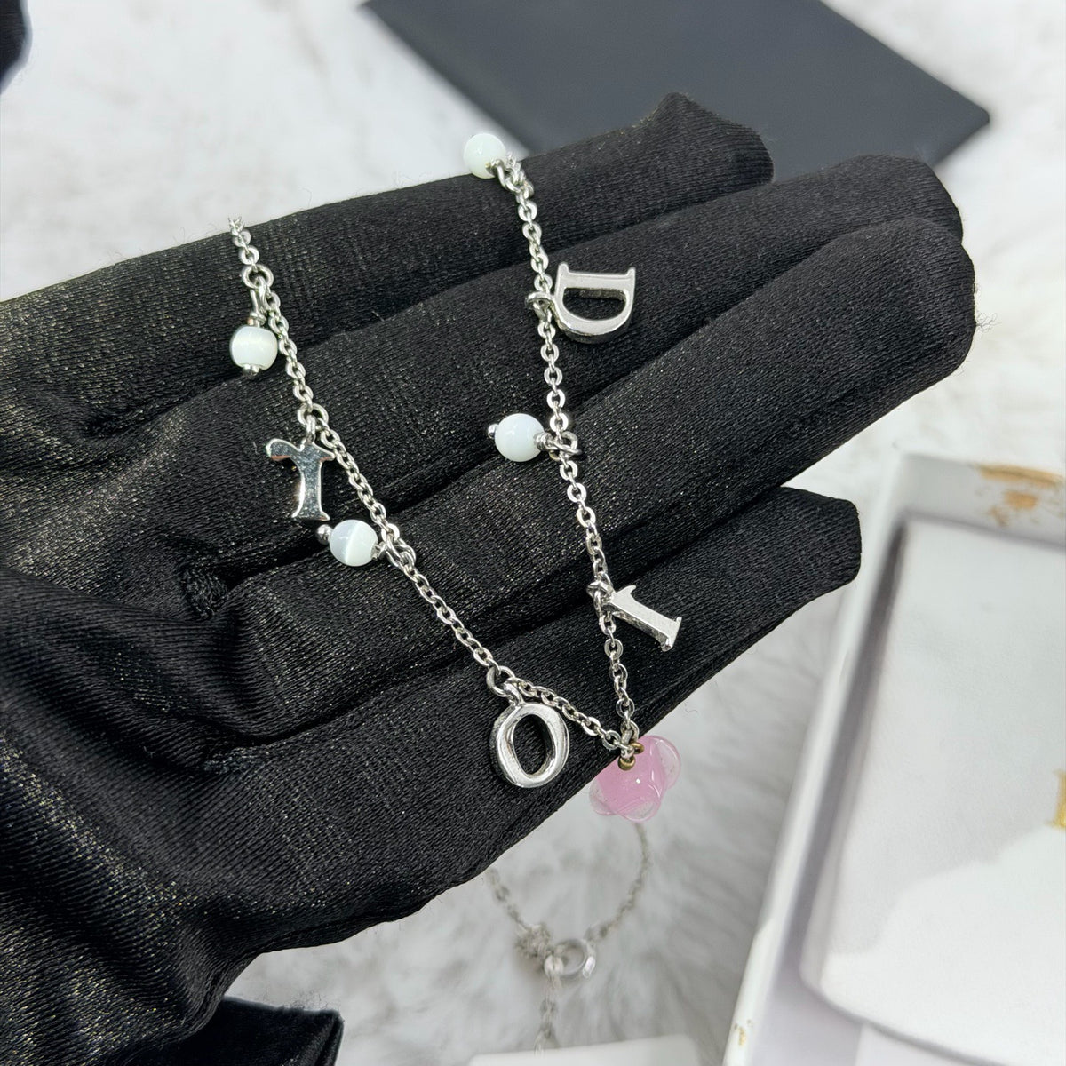 Dior - Other - Silver-tone metal chain and charms with decorative stones, white bead accents and a glass flower charm. - Multicolour