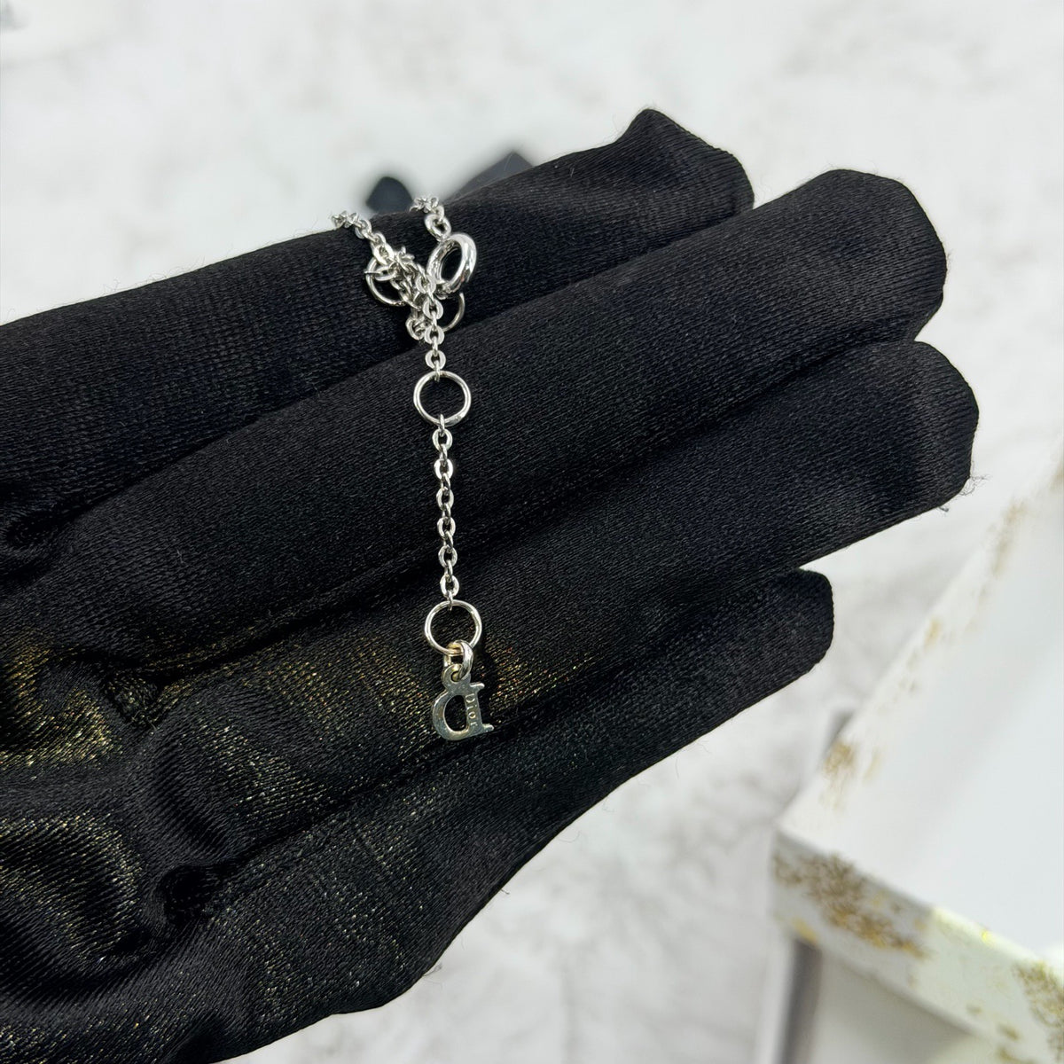 Dior - Other - Silver-tone metal chain and charms with decorative stones, white bead accents and a glass flower charm. - Multicolour