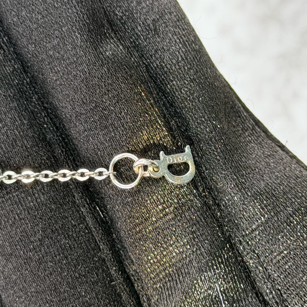 Dior - Other - Silver-tone metal chain and charms with decorative stones, white bead accents and a glass flower charm. - Multicolour