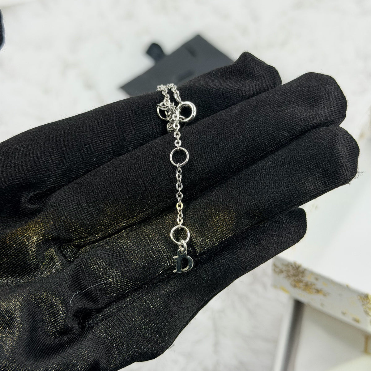 Dior - Other - Silver-tone metal chain and charms with decorative stones, white bead accents and a glass flower charm. - Multicolour