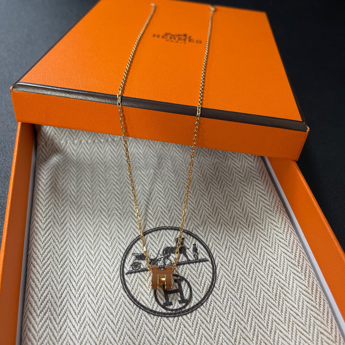 Hermes - Mini Pop H - Lacquered metal pendant with a rose-gold-tone metal chain; exact metal composition is not specified. - Orange