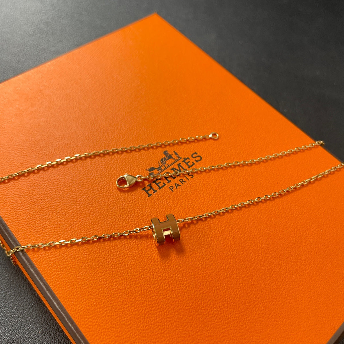 Hermes - Mini Pop H - Lacquered metal pendant with a rose-gold-tone metal chain; exact metal composition is not specified. - Orange
