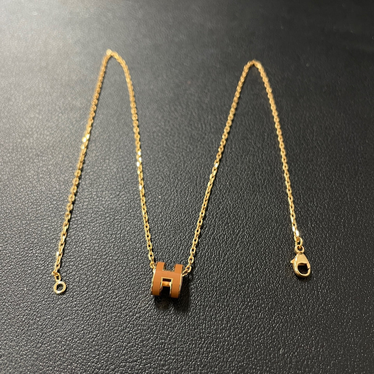 Hermes - Mini Pop H - Lacquered metal pendant with a rose-gold-tone metal chain; exact metal composition is not specified. - Orange