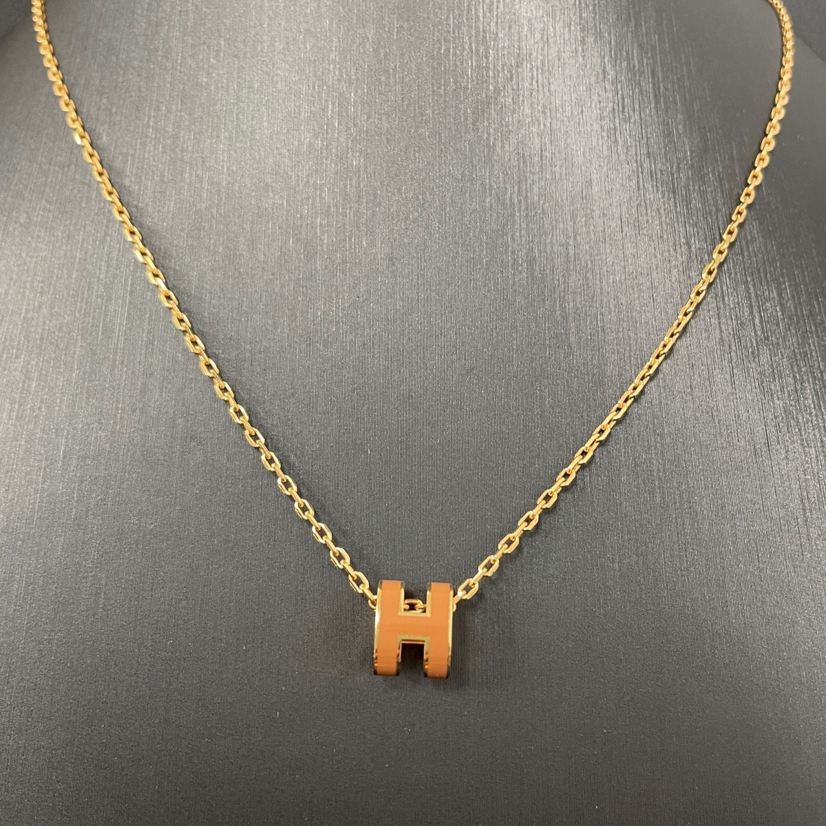 Hermes - Mini Pop H - Lacquered metal pendant with a rose-gold-tone metal chain; exact metal composition is not specified. - Orange