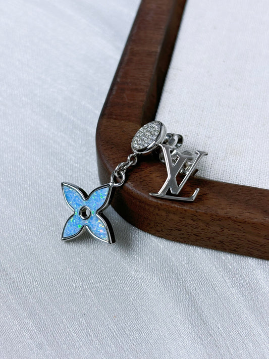 Louis Vuitton - Other - Silver-tone metal with clear crystal-like accents and blue iridescent inlay; exact composition of the accents and inlay is unconfirmed. - Multicolour