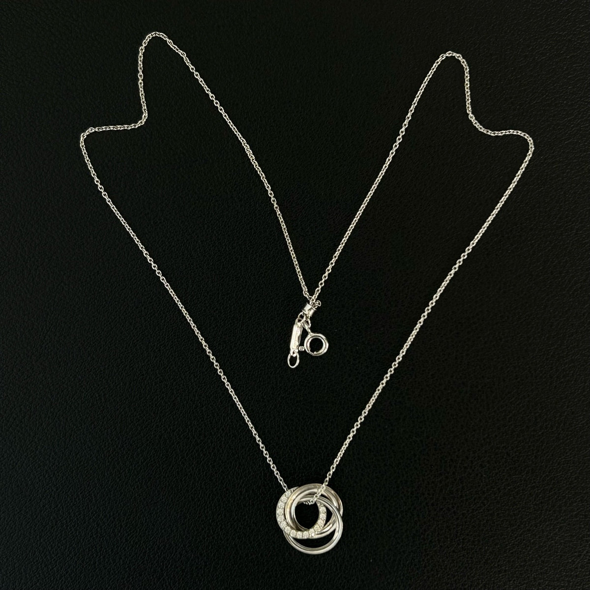 Tiffany & Co. - Interlocking Circles - Sterling silver; the pendant appears to bear a 925 hallmark. One circle is set with pave diamonds. - Silver