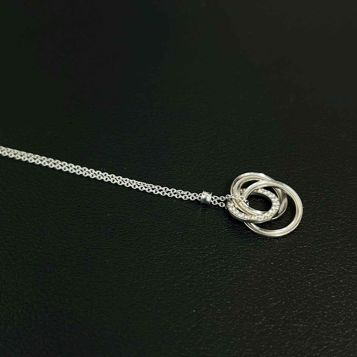 Tiffany & Co. - Interlocking Circles - Sterling silver; the pendant appears to bear a 925 hallmark. One circle is set with pave diamonds. - Silver