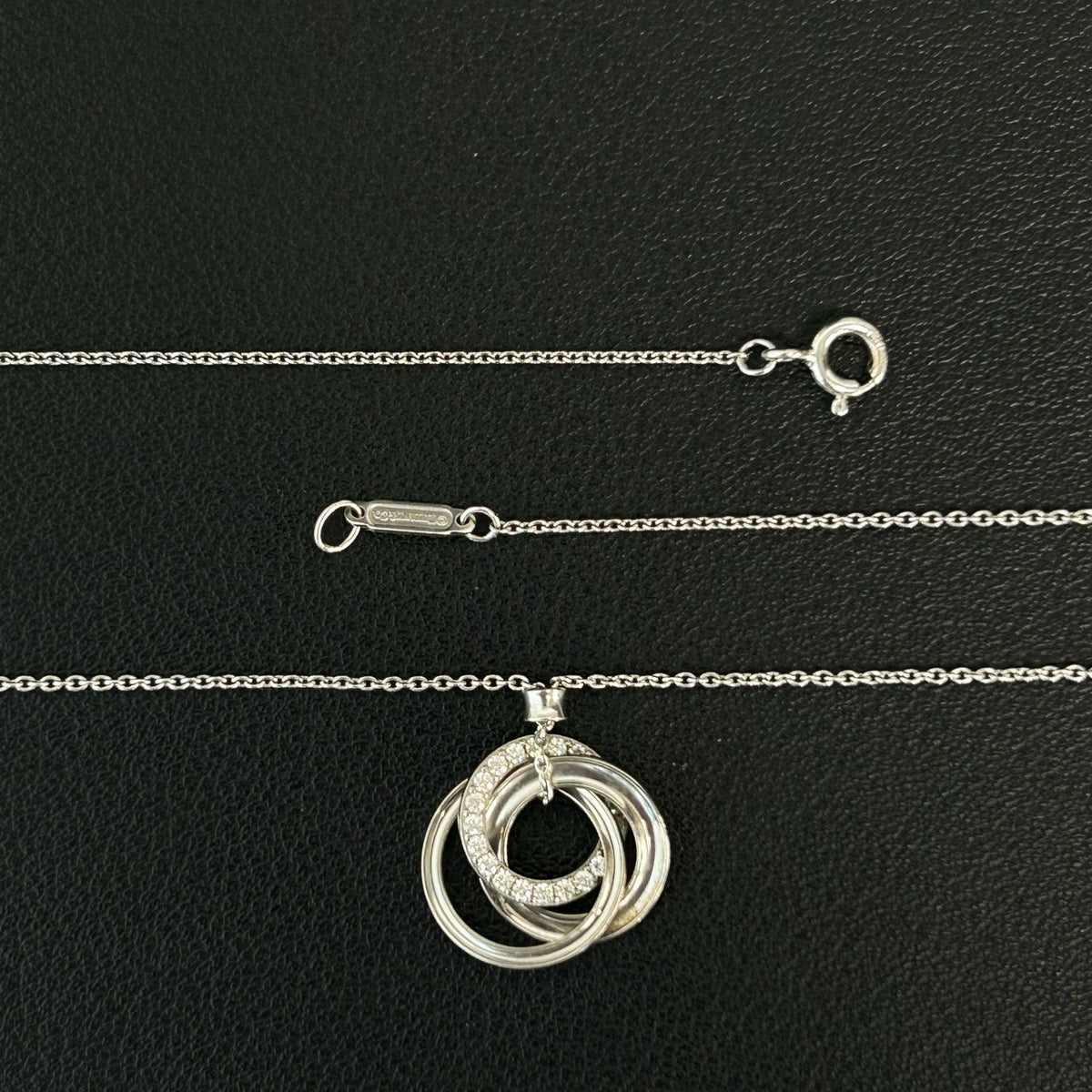 Tiffany & Co. - Interlocking Circles - Sterling silver; the pendant appears to bear a 925 hallmark. One circle is set with pave diamonds. - Silver