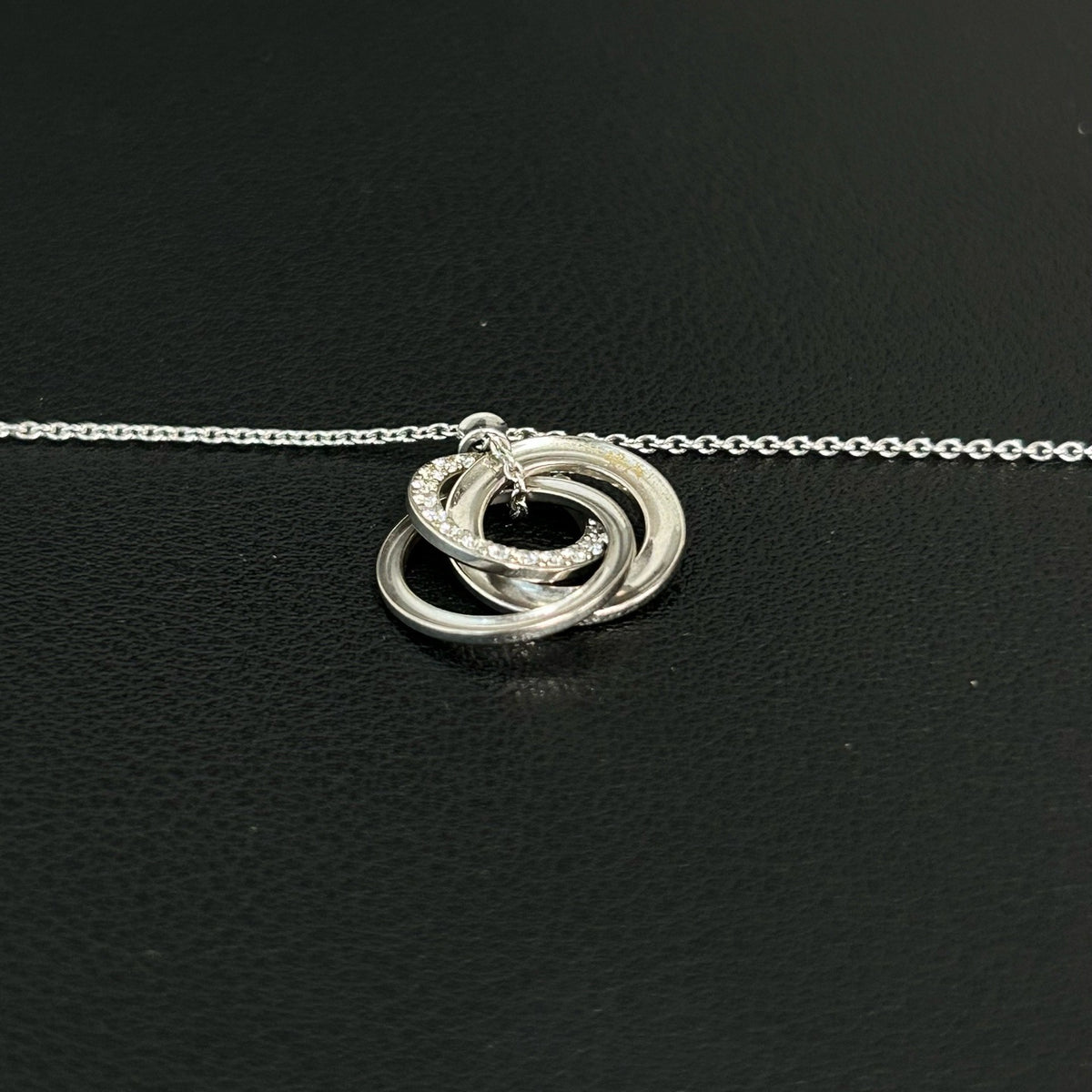 Tiffany & Co. - Interlocking Circles - Sterling silver; the pendant appears to bear a 925 hallmark. One circle is set with pave diamonds. - Silver