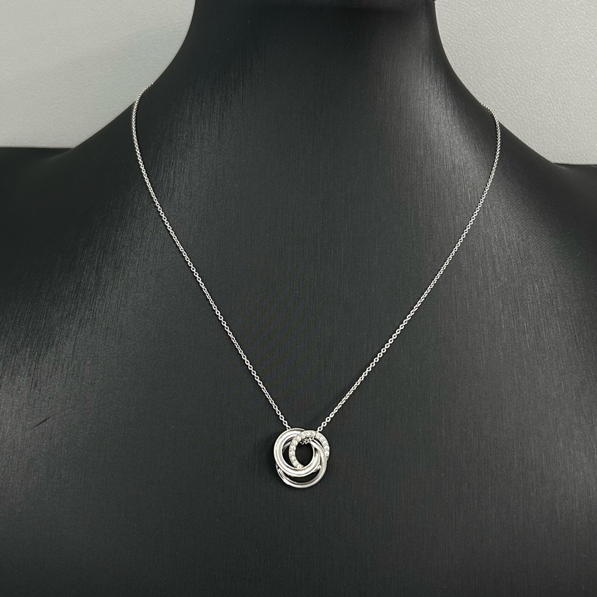 Tiffany & Co. - Interlocking Circles - Sterling silver; the pendant appears to bear a 925 hallmark. One circle is set with pave diamonds. - Silver