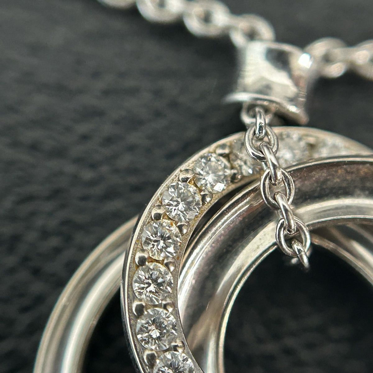 Tiffany & Co. - Interlocking Circles - Sterling silver; the pendant appears to bear a 925 hallmark. One circle is set with pave diamonds. - Silver