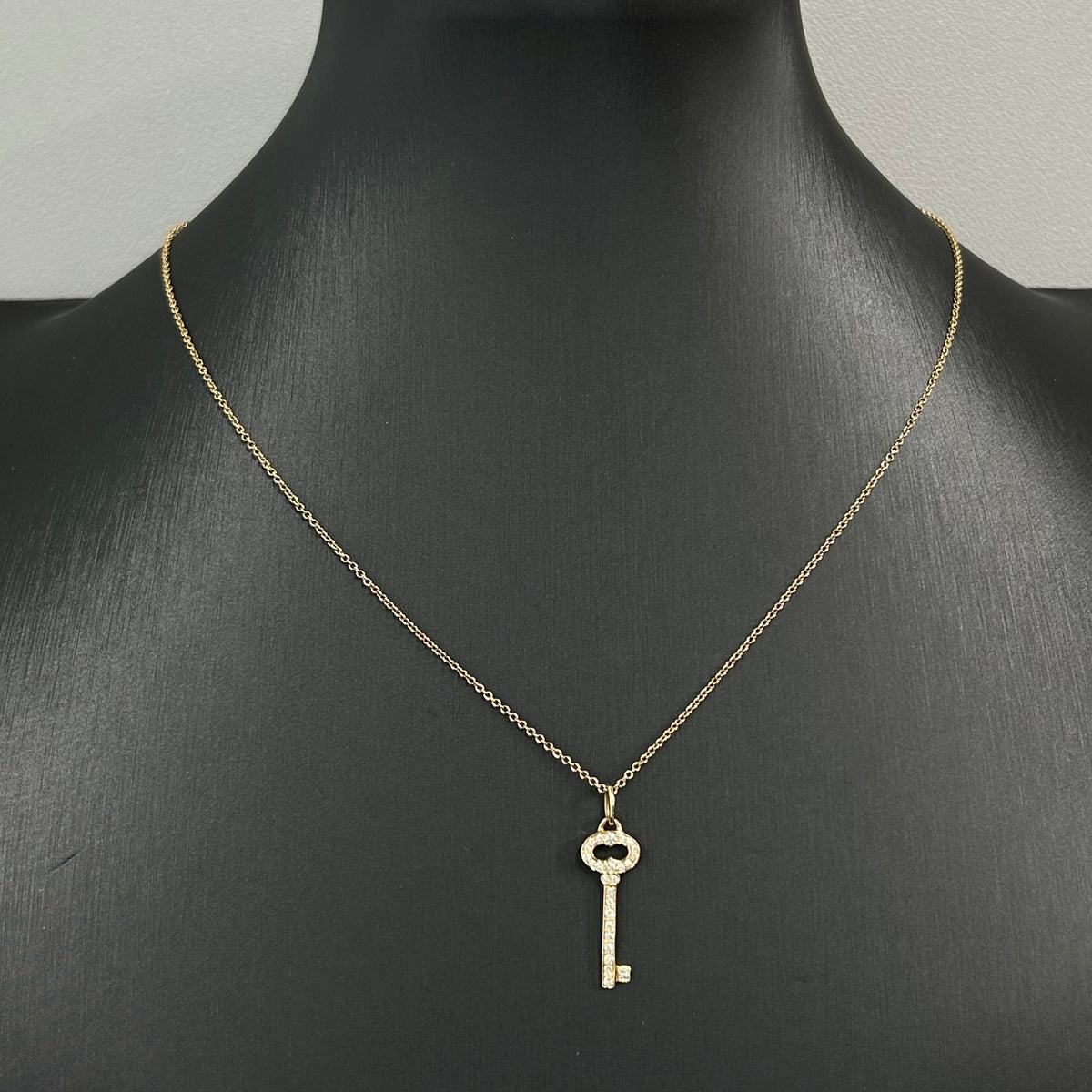 Tiffany & Co. - Keys Oval Key - 18K gold with natural diamonds; the pendant is stamped 0.14 ct. - Gold